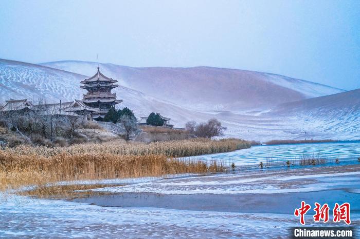 2021年11月28日，雪落鳴沙山月牙泉景區(qū)?！⊥醣筱y 攝