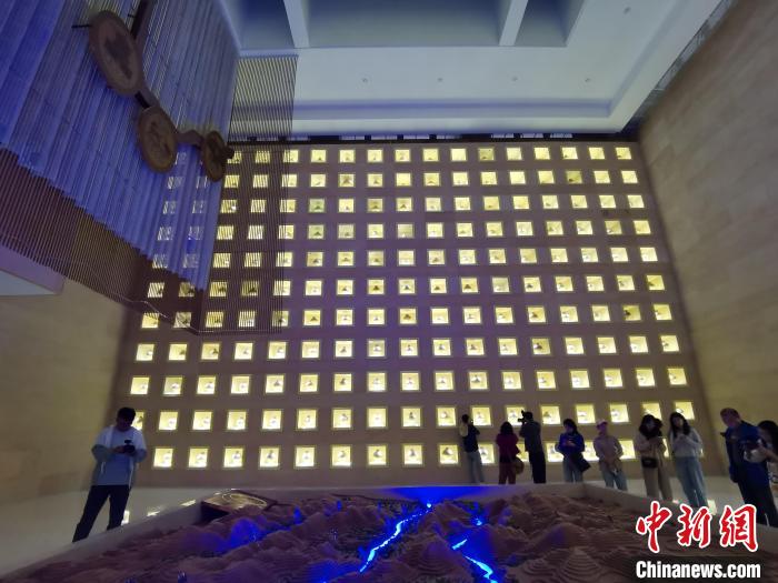 圖為河湟文化博物館序廳的左右彩陶墻放置的374件彩陶?！?zhí)砀?攝